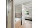 Bathroom with shower and bathtub, neutral color palette, and a view of the bedroom at 2995 Boulder Walk Se Ct, Atlanta, GA 30316