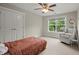 Cozy bedroom featuring plush carpet, chair, and a ceiling fan, offering a comfortable and inviting space at 2995 Boulder Walk Se Ct, Atlanta, GA 30316