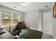 Bright bedroom featuring a large window, neutral walls, and a green rug at 2995 Boulder Walk Se Ct, Atlanta, GA 30316