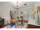 Charming dining room with wood table, chandelier, and views into the living room and up the staircase at 2995 Boulder Walk Se Ct, Atlanta, GA 30316