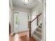 Inviting foyer featuring hardwood floors, staircase, and natural light from sidelight windows flanking the front door at 2995 Boulder Walk Se Ct, Atlanta, GA 30316