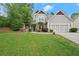 Exterior showcasing manicured lawn, two-car garage and inviting entry at 2995 Boulder Walk Se Ct, Atlanta, GA 30316