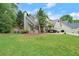 Beautiful home with a well-maintained front yard, lush lawn, mature trees, and manicured landscaping on a sunny day at 2995 Boulder Walk Se Ct, Atlanta, GA 30316