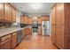 Well-lit kitchen with stainless appliances, hardwood floors and wood cabinetry at 2995 Boulder Walk Se Ct, Atlanta, GA 30316