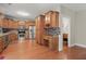 Spacious kitchen featuring wood cabinets, stainless steel appliances, and a mosaic backsplash at 2995 Boulder Walk Se Ct, Atlanta, GA 30316