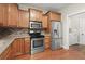 Well-equipped kitchen with stainless steel appliances, granite countertops, and wooden cabinetry at 2995 Boulder Walk Se Ct, Atlanta, GA 30316