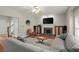 Cozy living room with a fireplace, hardwood floors, and comfortable seating, adjacent to entryway and dining area at 2995 Boulder Walk Se Ct, Atlanta, GA 30316