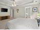 Large main bedroom with tray ceiling, television and entry to ensuite bathroom at 2995 Boulder Walk Se Ct, Atlanta, GA 30316
