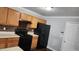 Kitchen with wooden cabinets and black appliances at 3777 Harvest Dr, Decatur, GA 30034