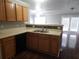 Kitchen with wooden cabinets, stainless steel sink and access to the living room at 3777 Harvest Dr, Decatur, GA 30034