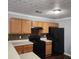 Kitchen with wooden cabinets and black appliances at 3777 Harvest Dr, Decatur, GA 30034