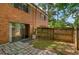 Backyard with a sliding glass door, brick patio, and wooden fence surrounding a grassy area at 6593 Sleepy Hollow Ln, Morrow, GA 30260