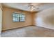 Comfortable bedroom featuring plush carpet, neutral walls, and a ceiling fan at 6593 Sleepy Hollow Ln, Morrow, GA 30260