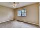 Bright bedroom with neutral carpet and paint, a ceiling fan, and natural light from a window at 6593 Sleepy Hollow Ln, Morrow, GA 30260