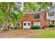 Traditional brick townhouse with a lush green lawn and mature trees at 6593 Sleepy Hollow Ln, Morrow, GA 30260