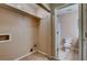 Laundry room with tile flooring, and includes shelving with a view to a bathroom at 6593 Sleepy Hollow Ln, Morrow, GA 30260