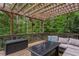 Relaxing back deck features an outdoor seating area, storage and wooded views at 101 Fernwood Dr, Woodstock, GA 30188