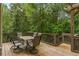 Inviting back deck with a wooden pergola and table, perfect for outdoor dining and enjoying the surrounding nature at 101 Fernwood Dr, Woodstock, GA 30188
