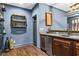 Chic basement wet bar boasts dark wood cabinets, granite counters, and a wine cooler at 101 Fernwood Dr, Woodstock, GA 30188