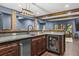 Entertain in style with a custom wet bar featuring granite counters, wood cabinets, and beverage cooler at 101 Fernwood Dr, Woodstock, GA 30188