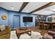 Finished basement with a bar, lounge area, dark wood beams, and recessed lighting at 101 Fernwood Dr, Woodstock, GA 30188