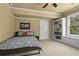 Cozy bedroom with a double bed, built-in shelving, and plenty of natural light at 101 Fernwood Dr, Woodstock, GA 30188