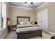 Cozy bedroom with a decorative bed, ample natural light from the shuttered window, and a closet at 101 Fernwood Dr, Woodstock, GA 30188
