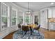 Breakfast nook features a circular table, backyard views and is adjacent to kitchen at 101 Fernwood Dr, Woodstock, GA 30188