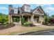 Charming community clubhouse featuring a stone fireplace, covered porch, and manicured landscaping at 101 Fernwood Dr, Woodstock, GA 30188