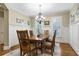 Elegant dining area with a wooden table, traditional chairs, and decorative wall trim at 101 Fernwood Dr, Woodstock, GA 30188