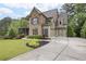 Beautiful home featuring a two-car garage, well-manicured lawn, and lush trees at 101 Fernwood Dr, Woodstock, GA 30188
