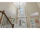 Grand foyer with a soaring ceiling, chandelier, double front doors, and staircase with wooden banister at 101 Fernwood Dr, Woodstock, GA 30188