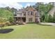 Charming home featuring well-manicured lawn, stone facade and covered porch at 101 Fernwood Dr, Woodstock, GA 30188