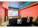 Home theater room with large screen, tiered seating, and a sophisticated sound system at 101 Fernwood Dr, Woodstock, GA 30188