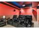 Home theater room featuring tiered seating, a projector, and surround sound system at 101 Fernwood Dr, Woodstock, GA 30188