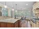 Bright kitchen boasts granite counters, stainless steel appliances, a range hood, and views of the backyard at 101 Fernwood Dr, Woodstock, GA 30188