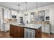 Modern kitchen includes stainless steel appliances, granite counters, a central island, and custom cabinets at 101 Fernwood Dr, Woodstock, GA 30188