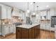Spacious kitchen features granite counters, a central island, stainless steel appliances, and custom cabinetry at 101 Fernwood Dr, Woodstock, GA 30188
