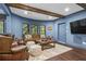Relax in a spacious basement with comfortable seating, wood beams, and a large entertainment area at 101 Fernwood Dr, Woodstock, GA 30188