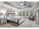 Tranquil main bedroom featuring a trey ceiling, bay window, and a comfortable sitting area for relaxation at 101 Fernwood Dr, Woodstock, GA 30188