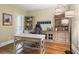 Well-lit home office with built-in shelving, desk, and hardwood floors at 101 Fernwood Dr, Woodstock, GA 30188