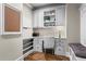Well-organized home office featuring custom built-ins, granite countertops, and a cozy bench seating area at 101 Fernwood Dr, Woodstock, GA 30188