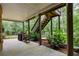 Covered patio with wood stairs leading up to deck and view of the lush backyard at 101 Fernwood Dr, Woodstock, GA 30188