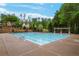 Community pool with swimming lanes, surrounded by a concrete deck and lush landscaping at 101 Fernwood Dr, Woodstock, GA 30188