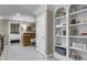 Upstairs hallway featuring a built-in bookshelf and desk with view into a bedroom at 101 Fernwood Dr, Woodstock, GA 30188