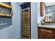 The basement bar features a modern built-in wine cooler for perfect wine storage and enjoyment at 101 Fernwood Dr, Woodstock, GA 30188