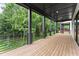 Covered back deck with black metal rails and plenty of space for outdoor enjoyment at 1420 Coretta Bnd, Atlanta, GA 30318