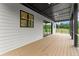 Covered back porch features wood floors and black metal railing, perfect for enjoying outdoor living at 1420 Coretta Bnd, Atlanta, GA 30318