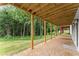 Exterior view of covered patio and backyard featuring mature trees at 1420 Coretta Bnd, Atlanta, GA 30318