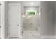 A stylish bathroom featuring a glass enclosed walk-in shower, marble tiles, and modern fixtures at 1420 Coretta Bnd, Atlanta, GA 30318